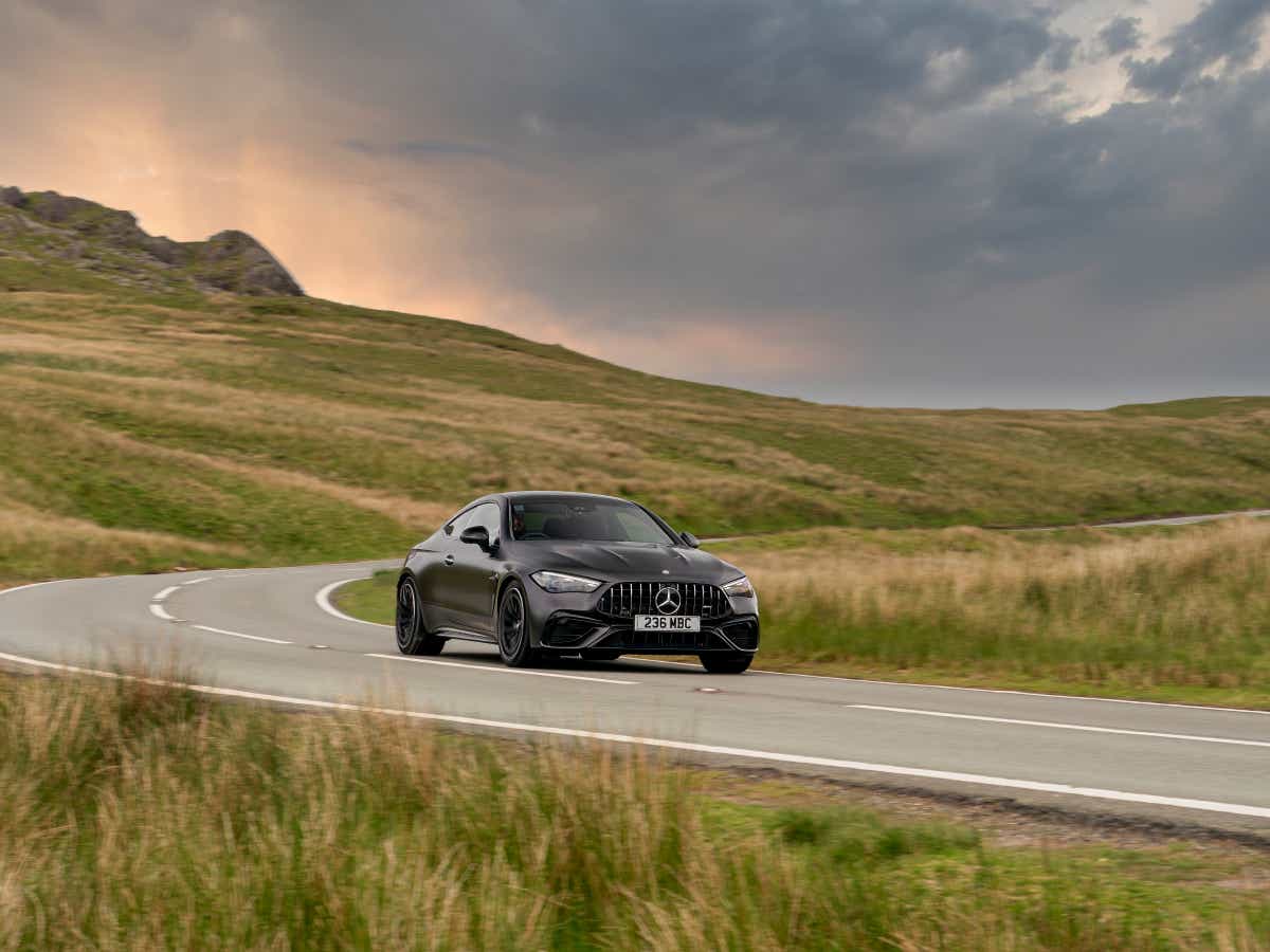 Front three-quarter view of a Mercedes-Benz AMG CLE 53 Coupe on a country road