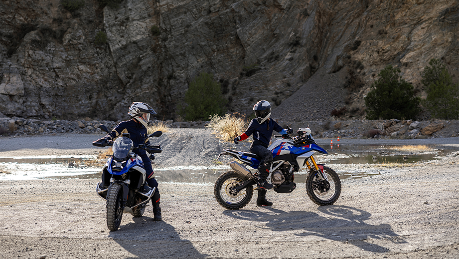 Outdoor view of a bmw f 450 gs with two riders near rocky terrain