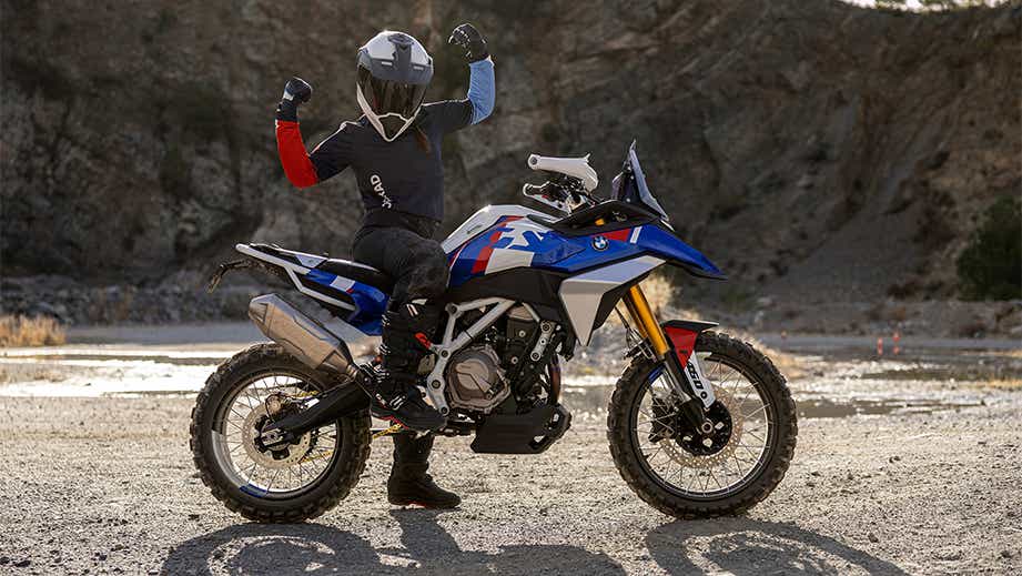 Side view of a BMW F 450 GS motorcycle with rider raising arms