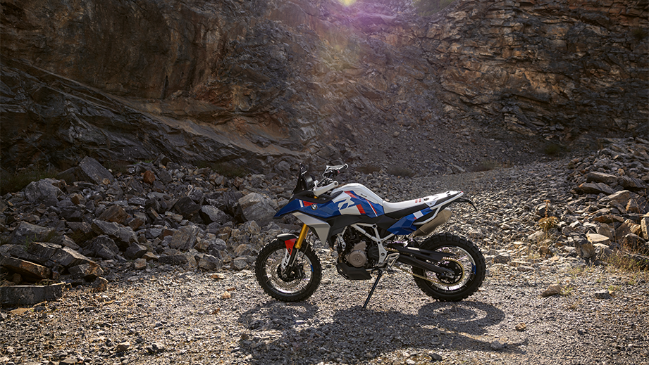 Side view of a BMW F 450 GS in a rocky outdoor setting