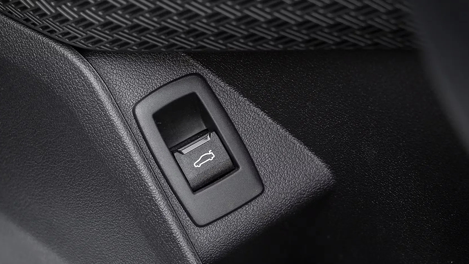 Close-up view of trunk release switch of BMW iX1 LWB