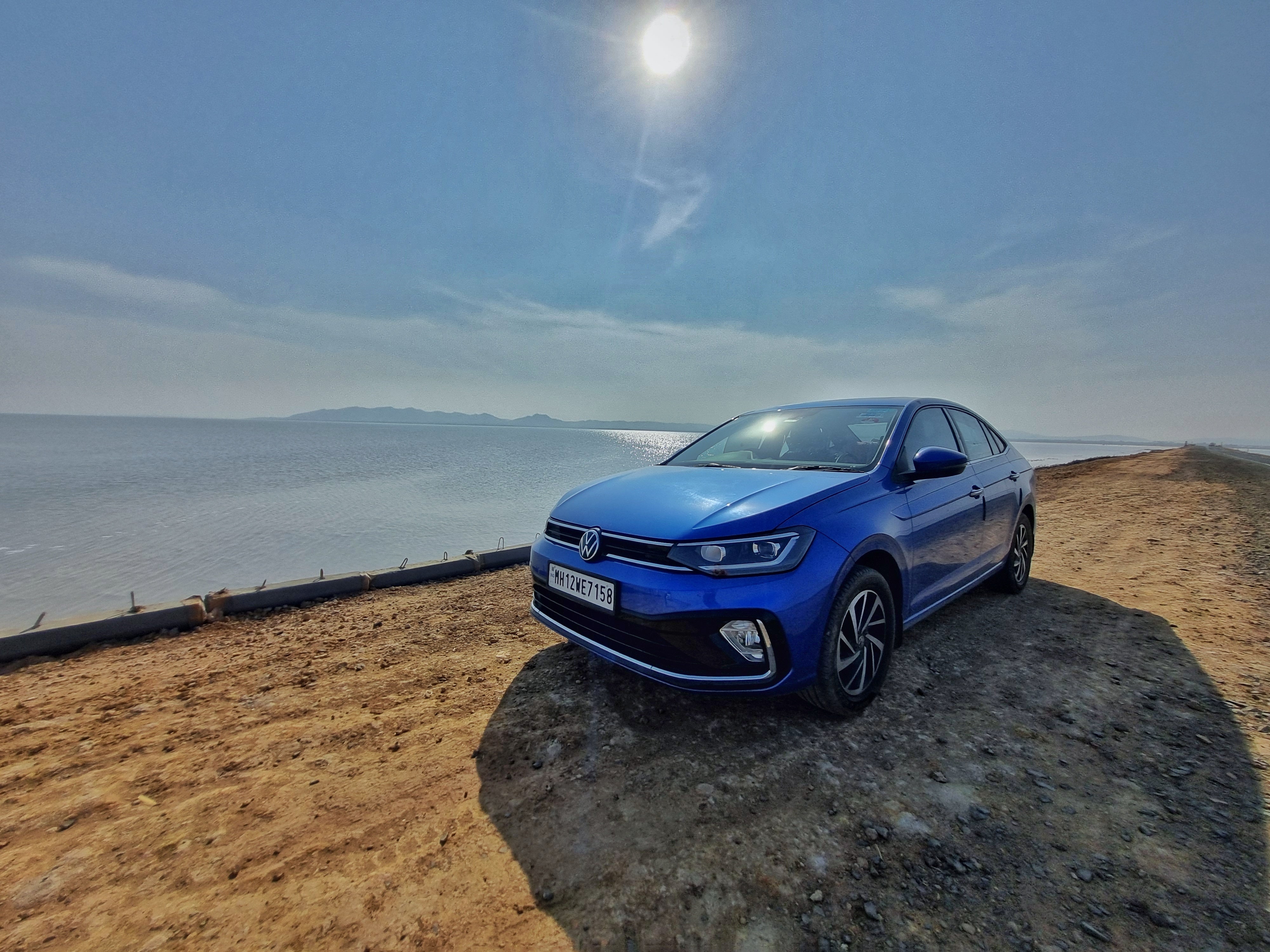 front three-quarter view of a Volkswagen Virtus by the seaside