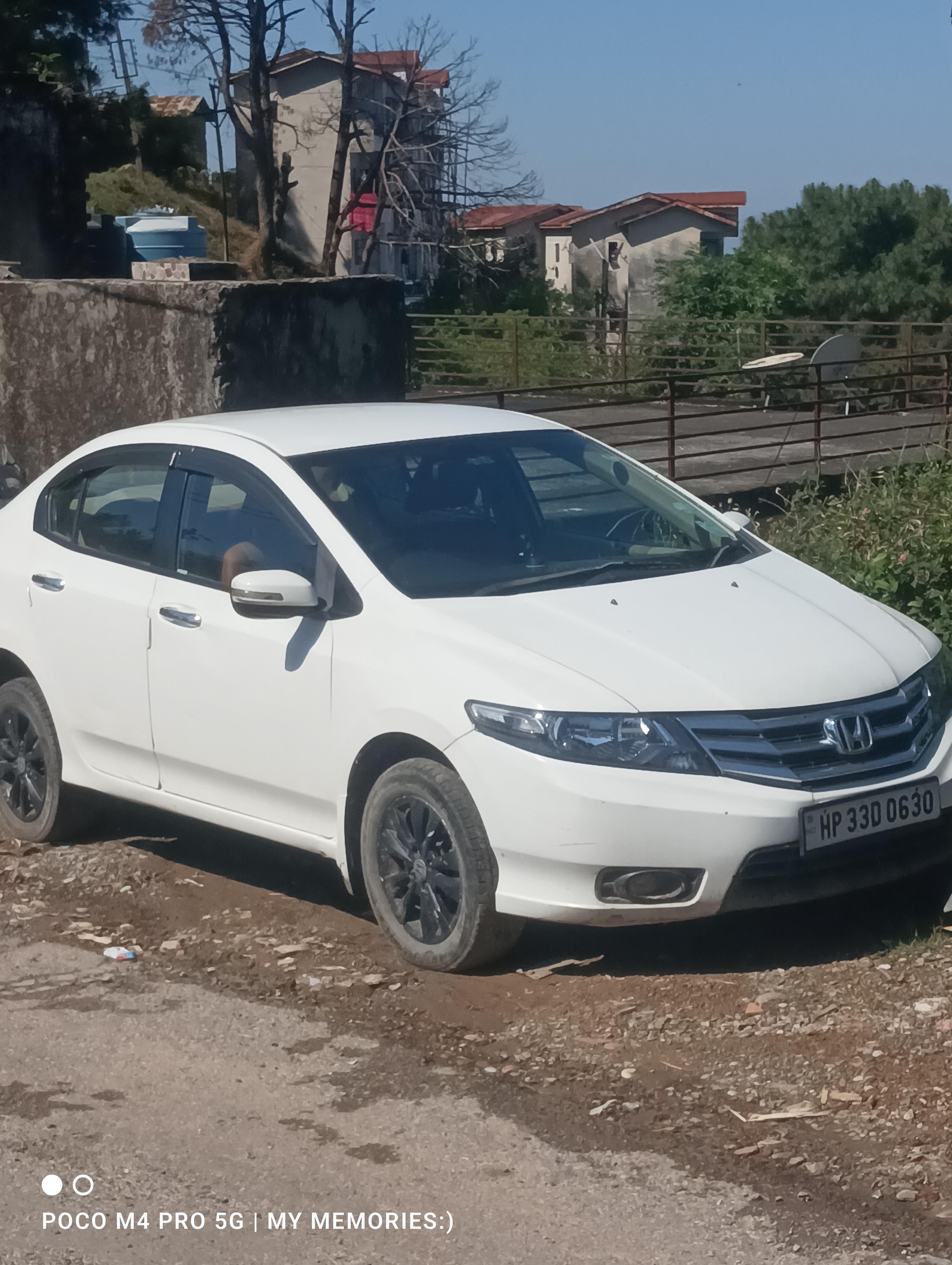 Front three-quarter of a platinum white pearl Honda City