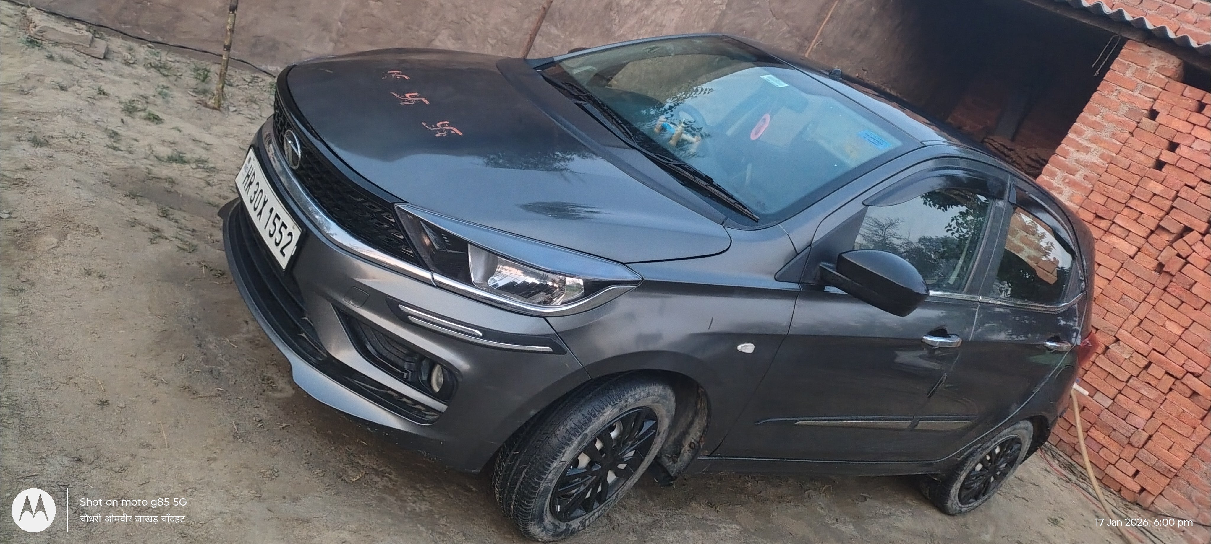 Front three-quarter view of a daytona-grey Tata Tiago