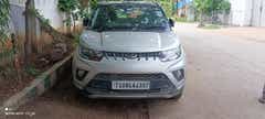 Front view of a dazzling silver Mahindra KUV 100 NXT