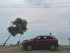 Side view of a opulent red Maruti Suzuki Grand Vitara