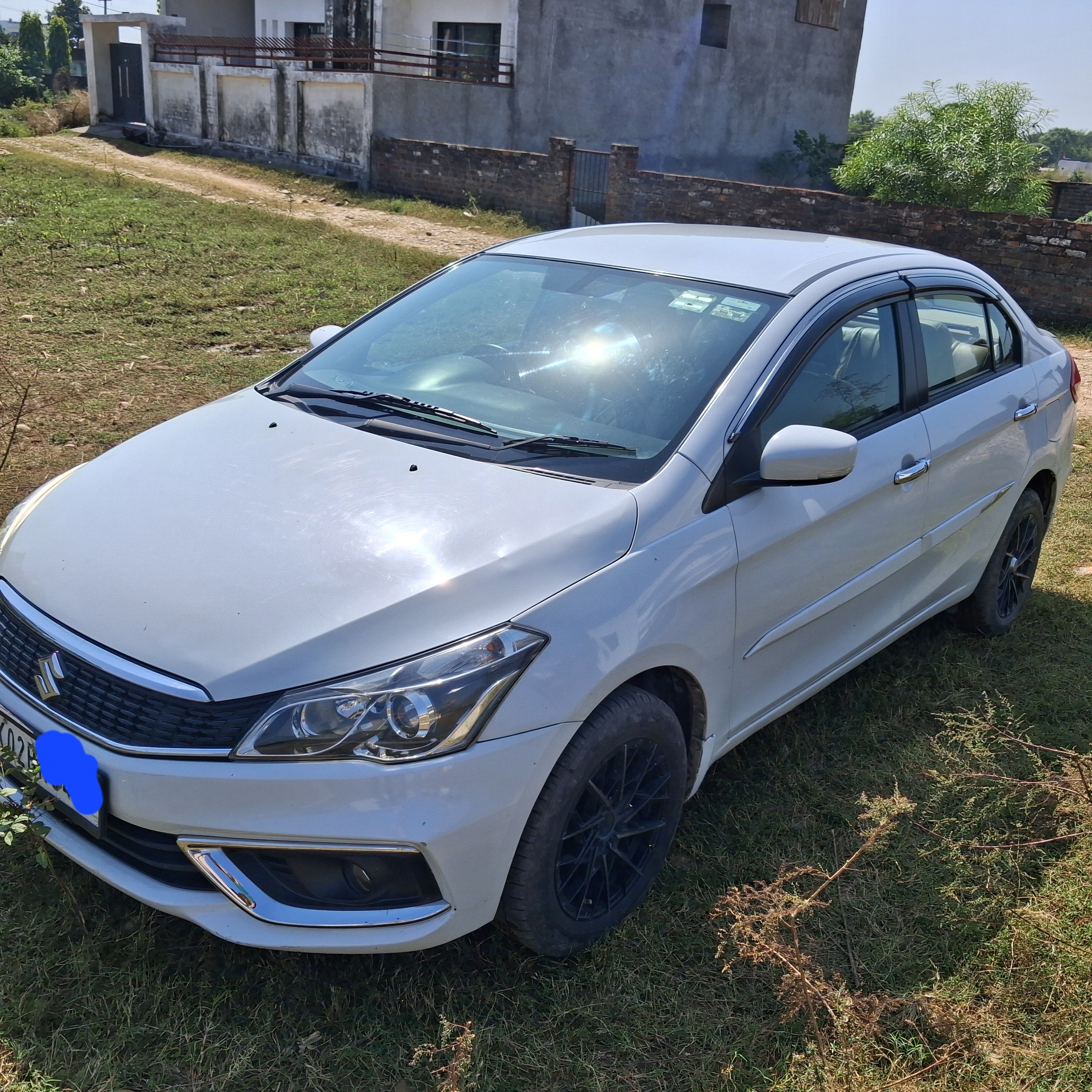 Front three-quarter view of a Pearl Arctic White Maruti Suzuki Ciaz