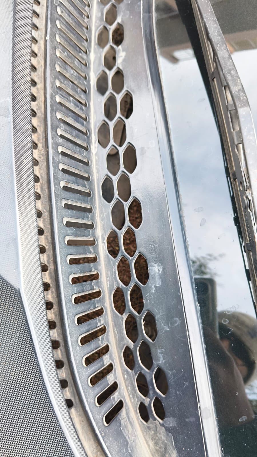 Close-up of a tata tiago windshield wiper and vent area