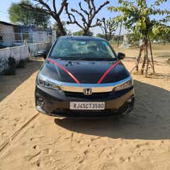 Front view of a obsidian blue pearl Honda City