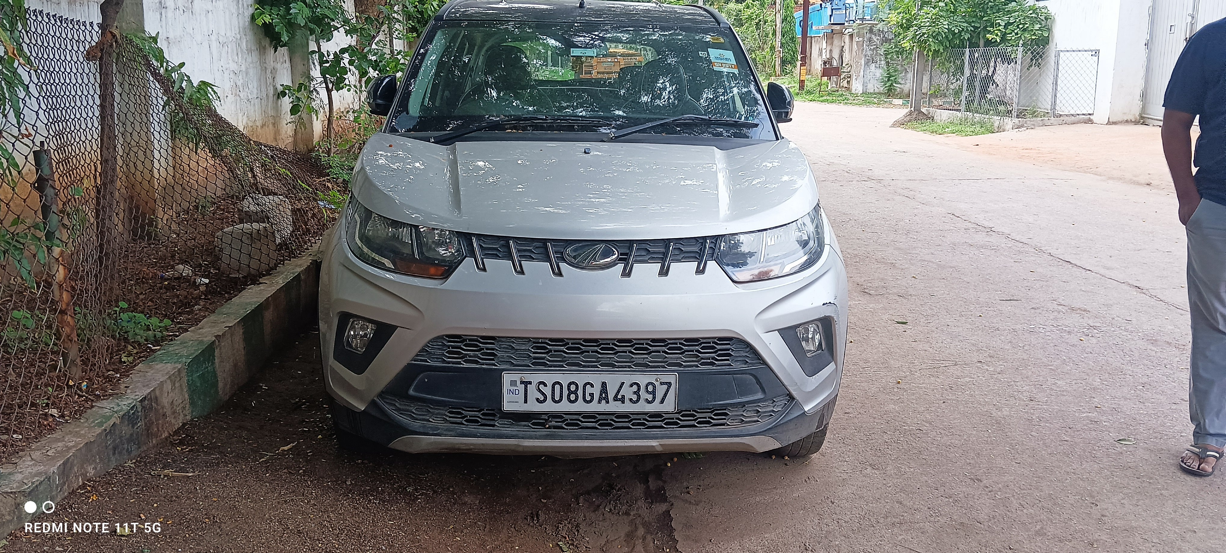 Front view of a dazzling-silver Mahindra KUV 100 NXT