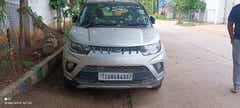 Front view of a dazzling-silver Mahindra KUV 100 NXT