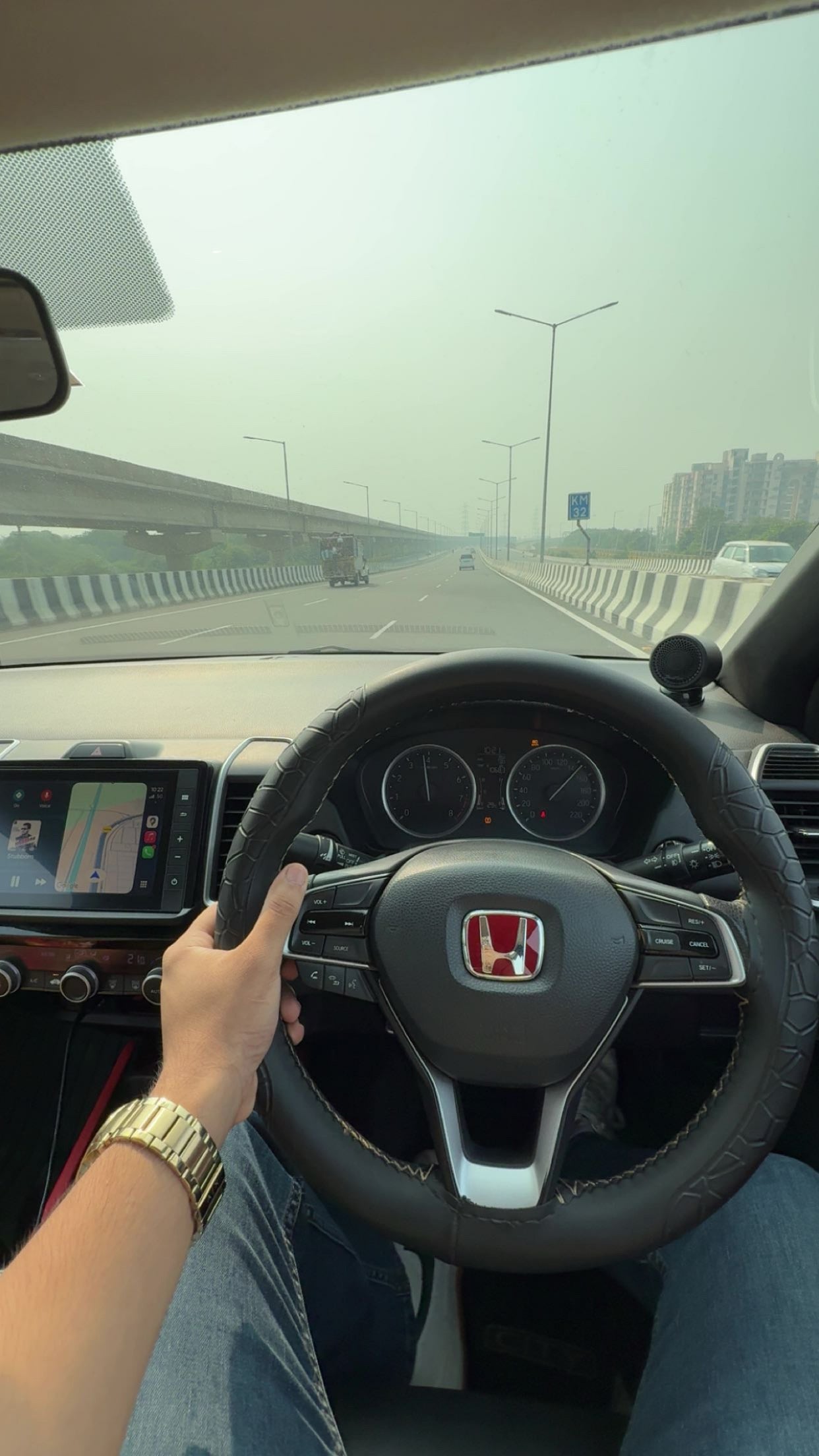 Driver's view of a Honda City interior dashboard and steering wheel
