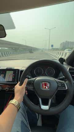 Driver's view of a Honda City interior dashboard and steering wheel