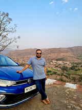 front three-quarter of a Volkswagen Virtus in a hilly landscape