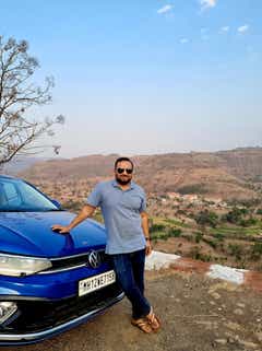 front three-quarter of a Volkswagen Virtus in a hilly landscape