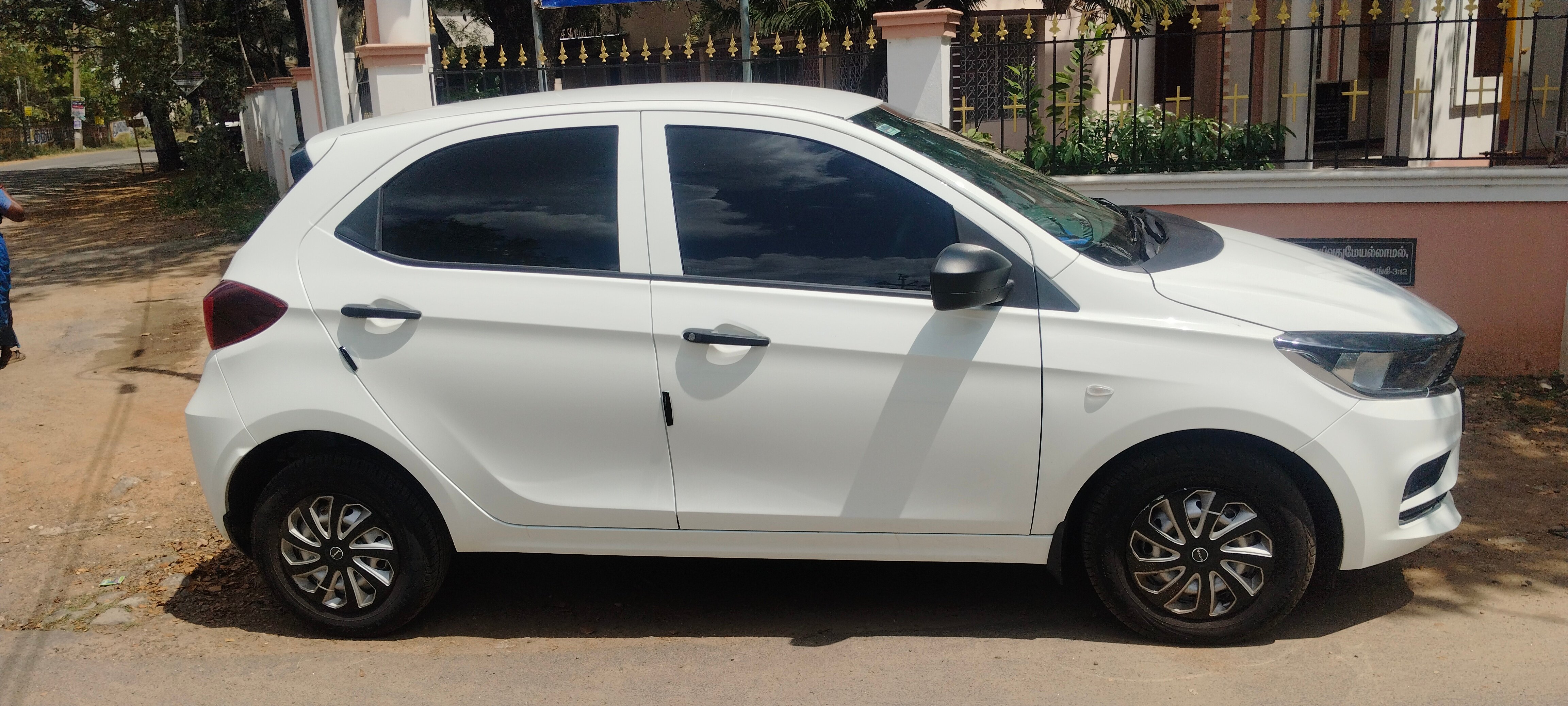 Side view of a pristine white Tata Tiago