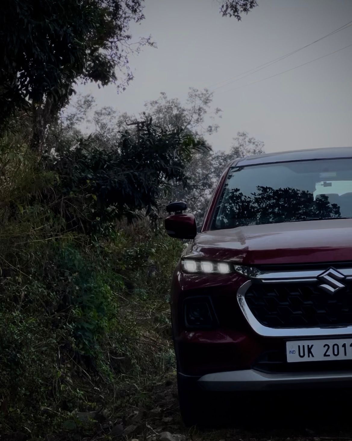 Front view of a opulent-red Maruti Suzuki Grand Vitara
