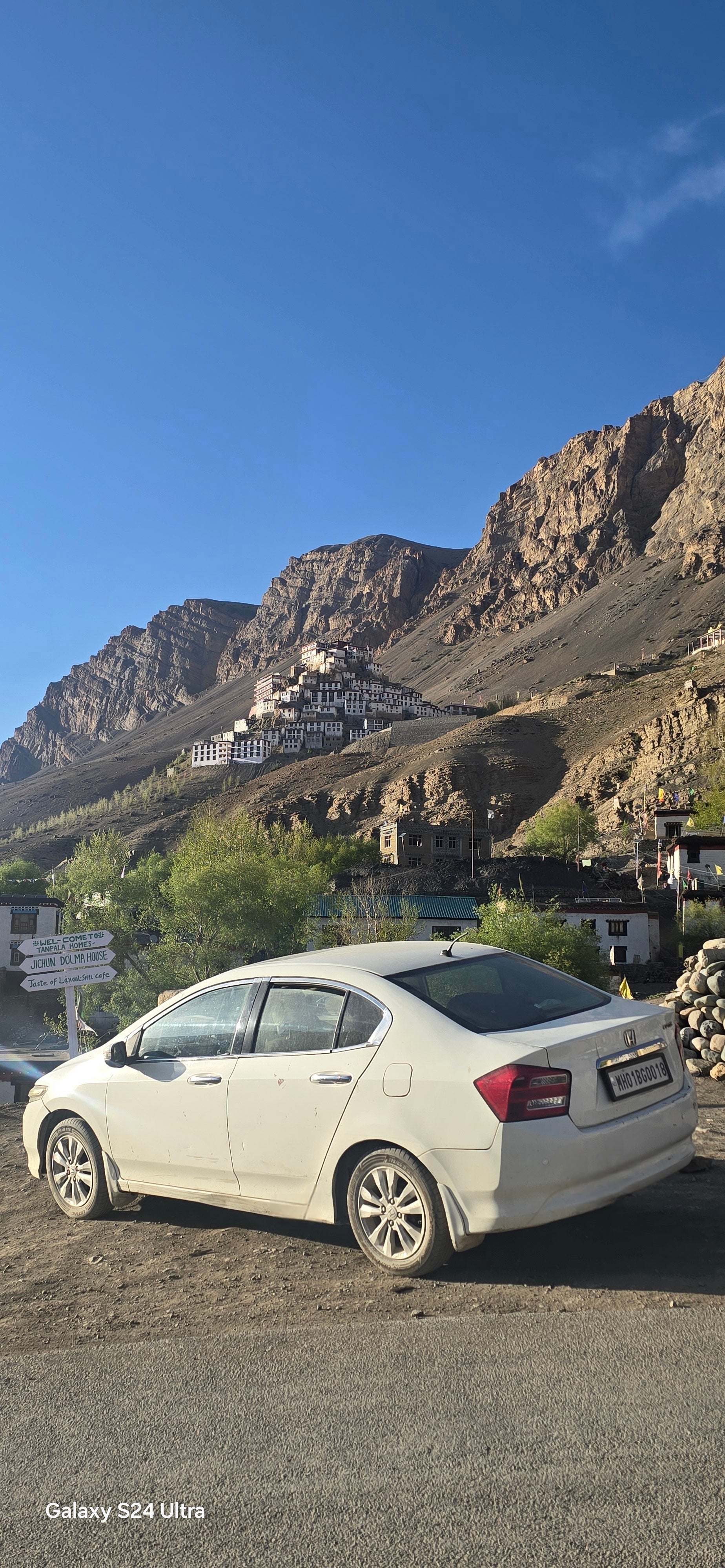 rear three-quarter of a Honda City near mountain village