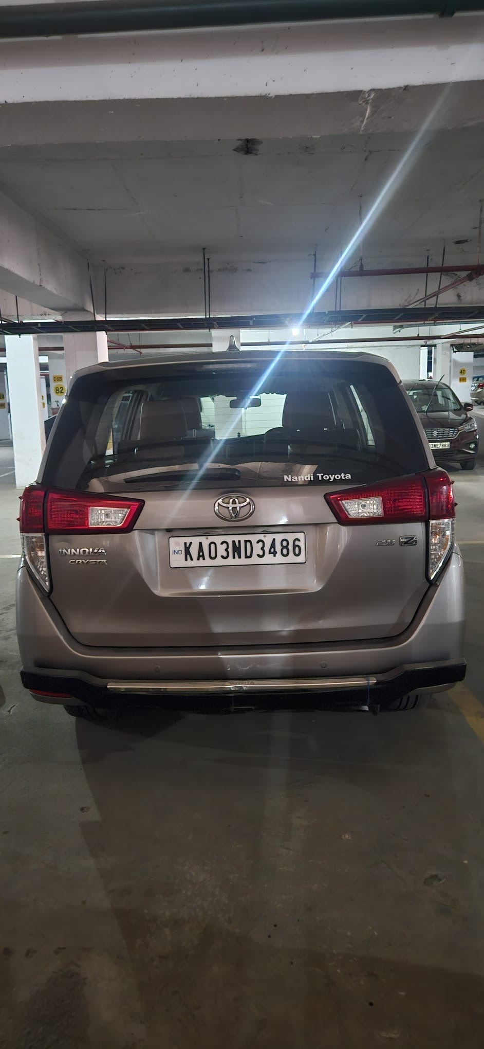 Rear view of a silver metallic Toyota Innova Crysta