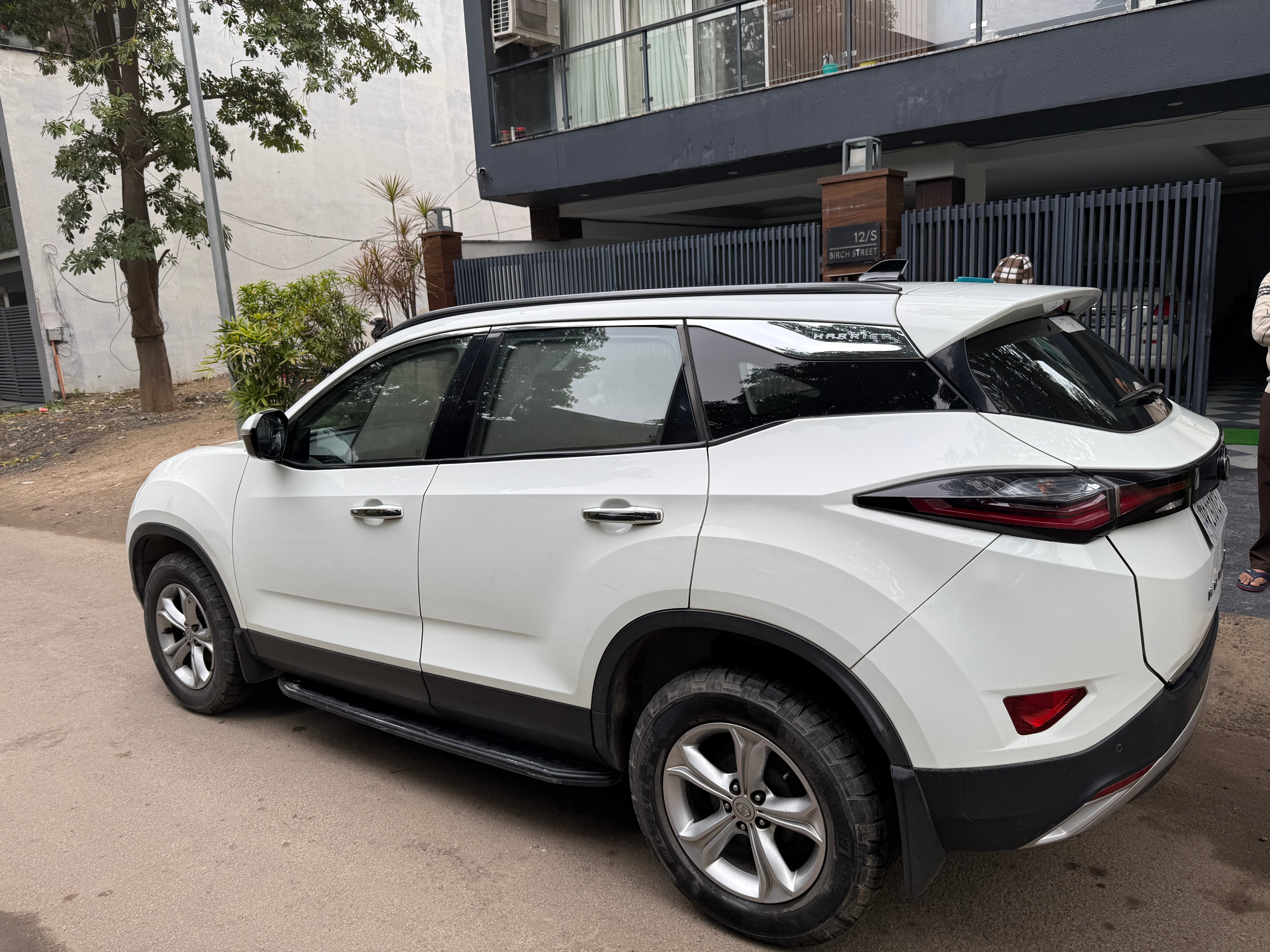Rear three-quarter view of a lunar white Tata Harrier