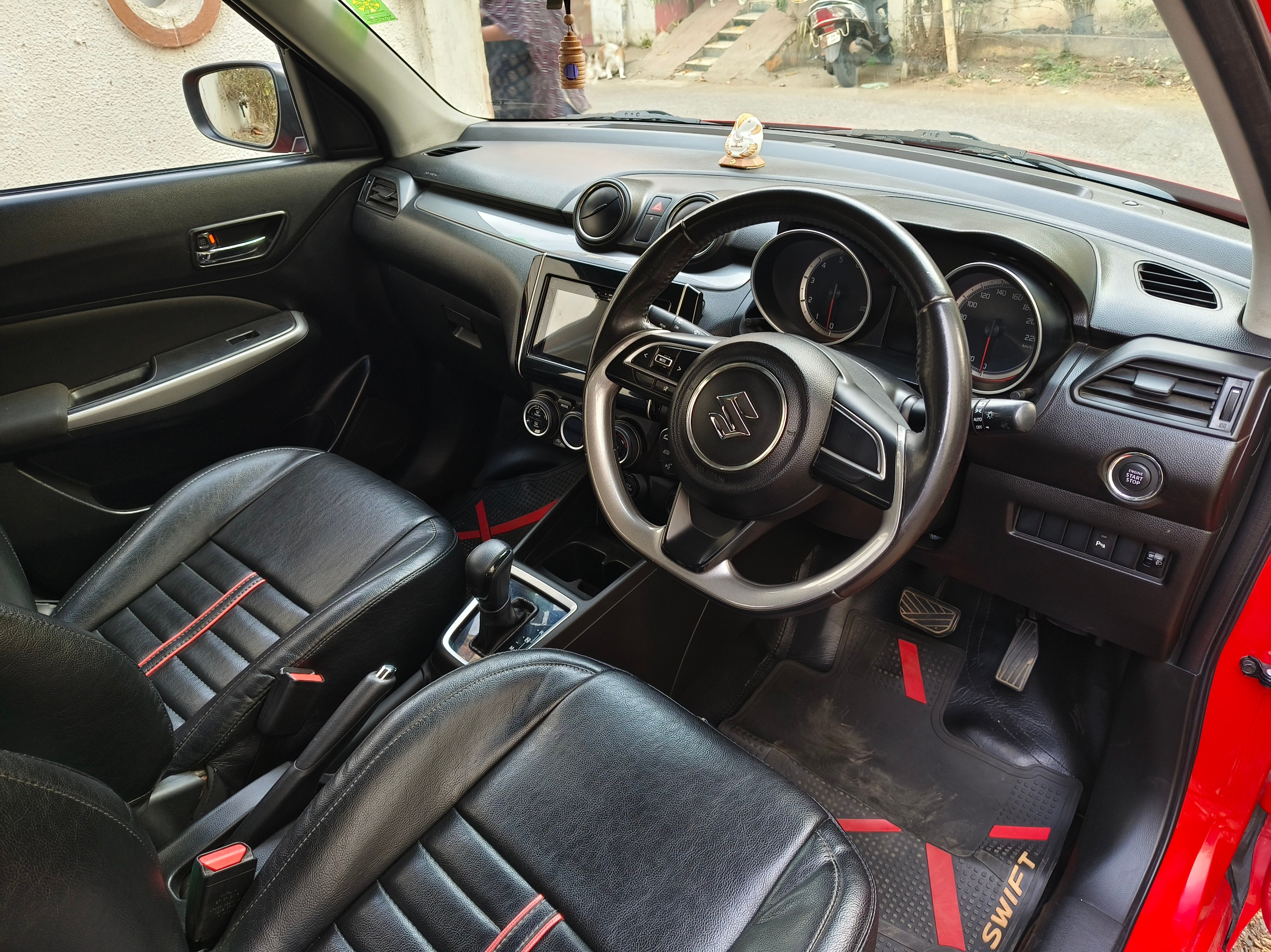 Interior dashboard view of a Maruti Suzuki Swift