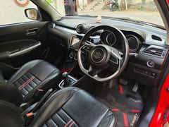 Interior dashboard view of a Maruti Suzuki Swift