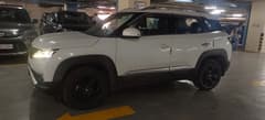 Side view of a Pearl Arctic White Maruti Suzuki Brezza