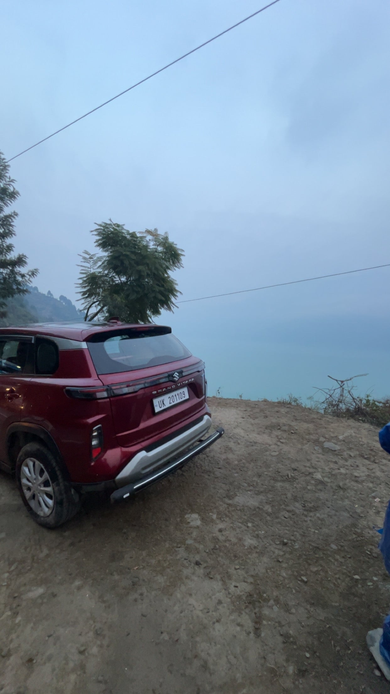 Rear three-quarter of a Opulent Red Maruti Suzuki Grand Vitara