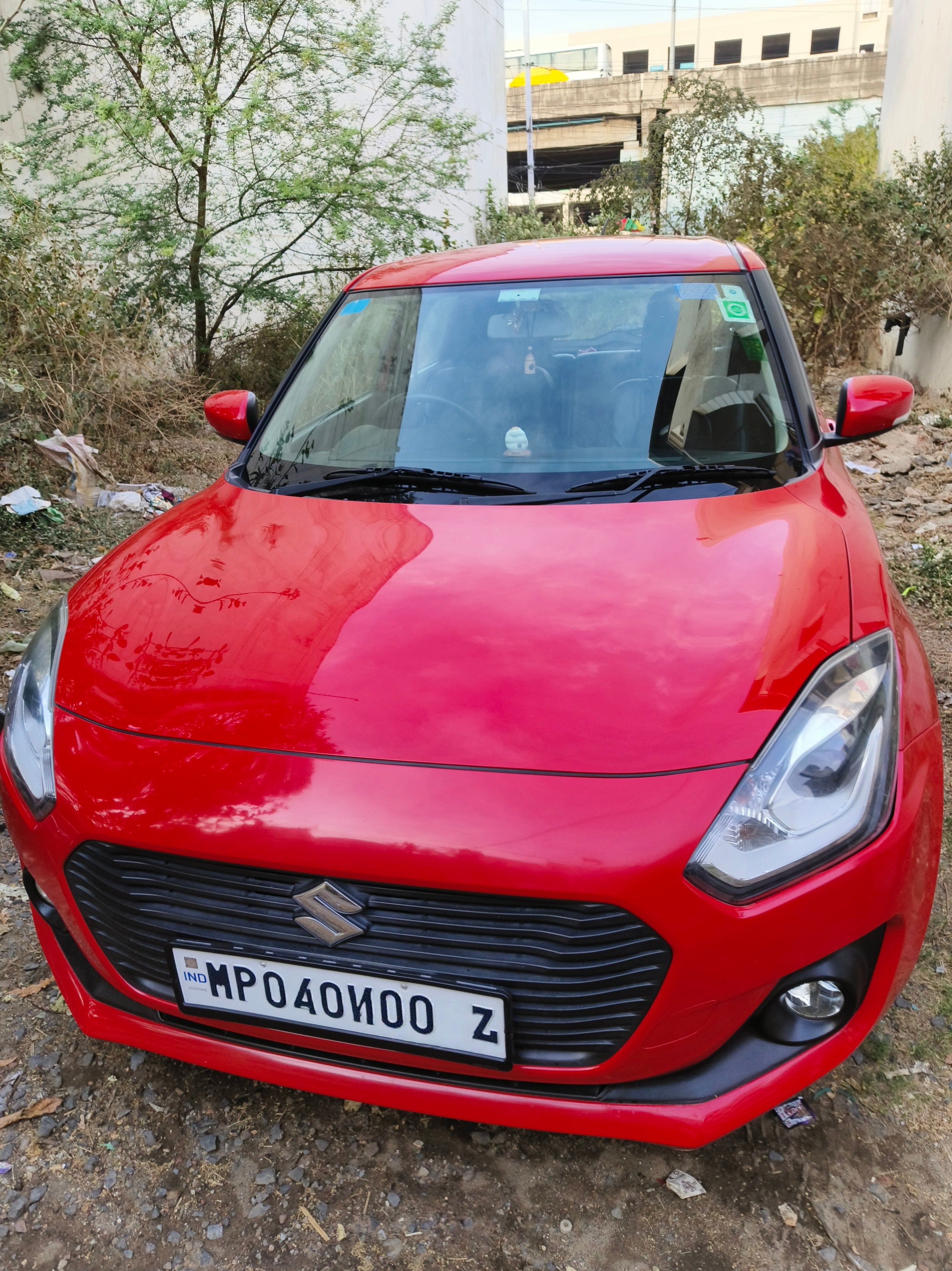 Front view of a Sizzling Red Maruti Suzuki Swift