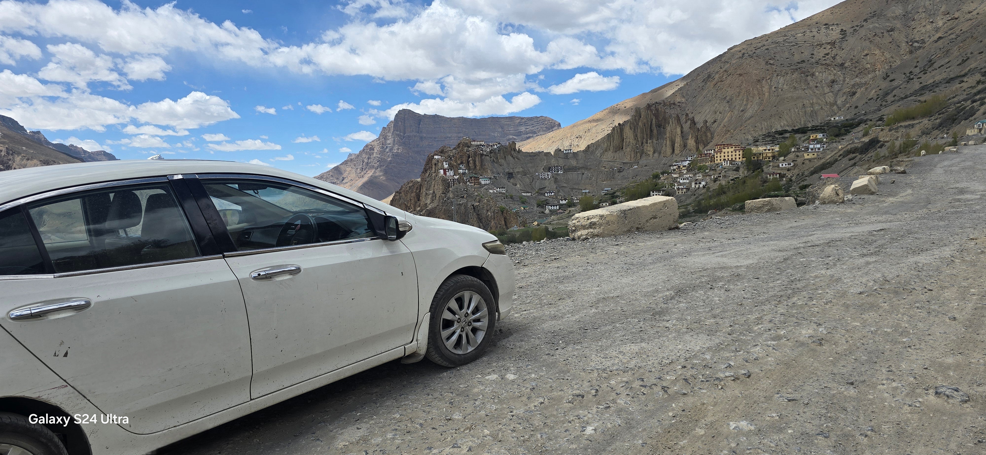Side view of a Honda City on a mountain road