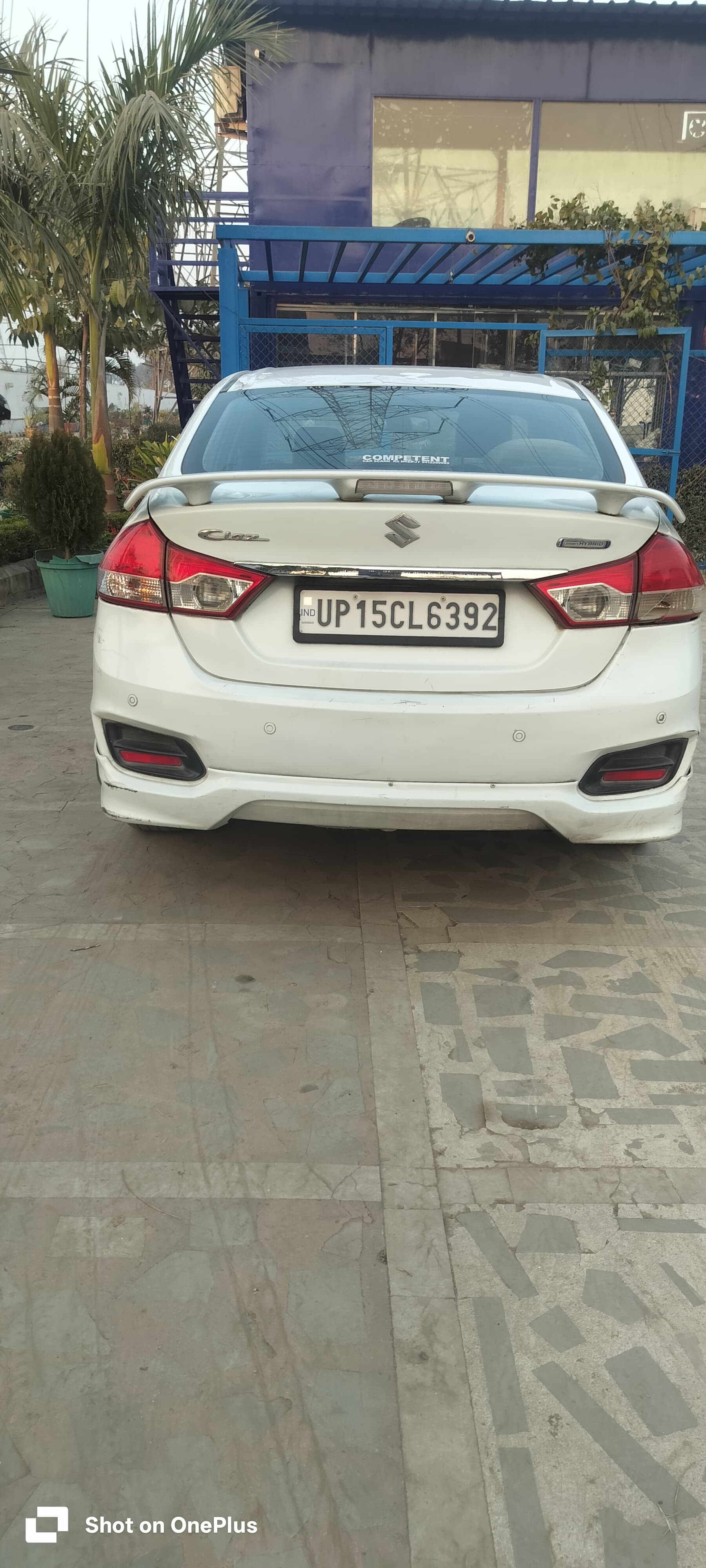 Rear view of a Pearl Arctic White Maruti Suzuki Ciaz