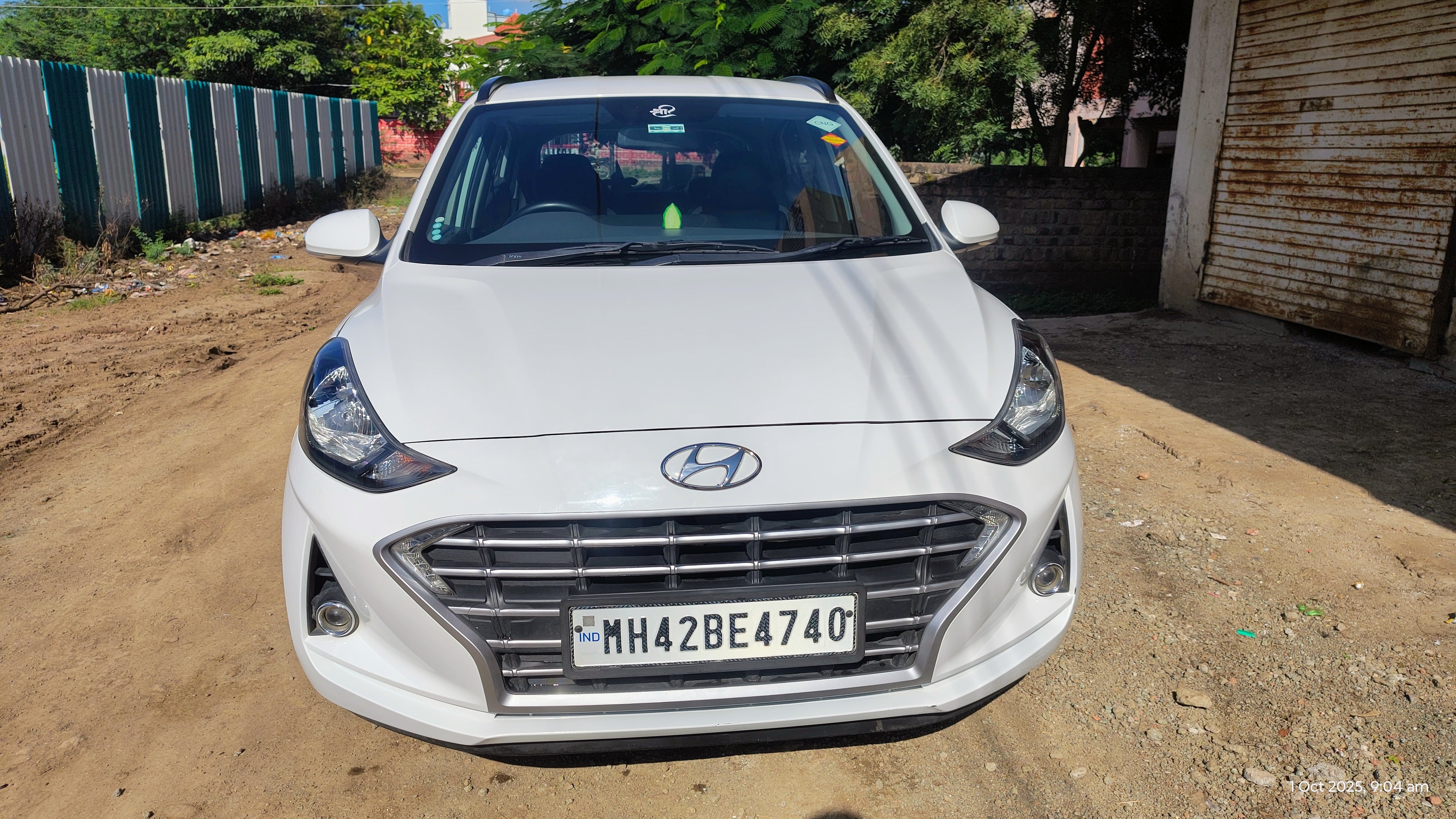 Front view of a atlas-white Hyundai Grand i10 Nios