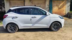 Side view of a atlas white Hyundai Grand i10 Nios