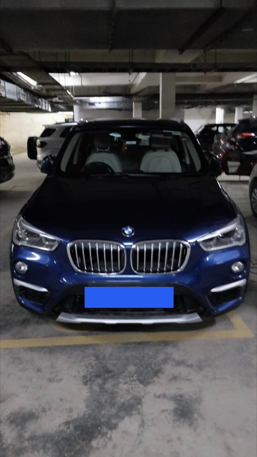 Front view of a portimao blue BMW X1