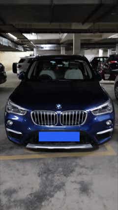 Front view of a portimao blue BMW X1