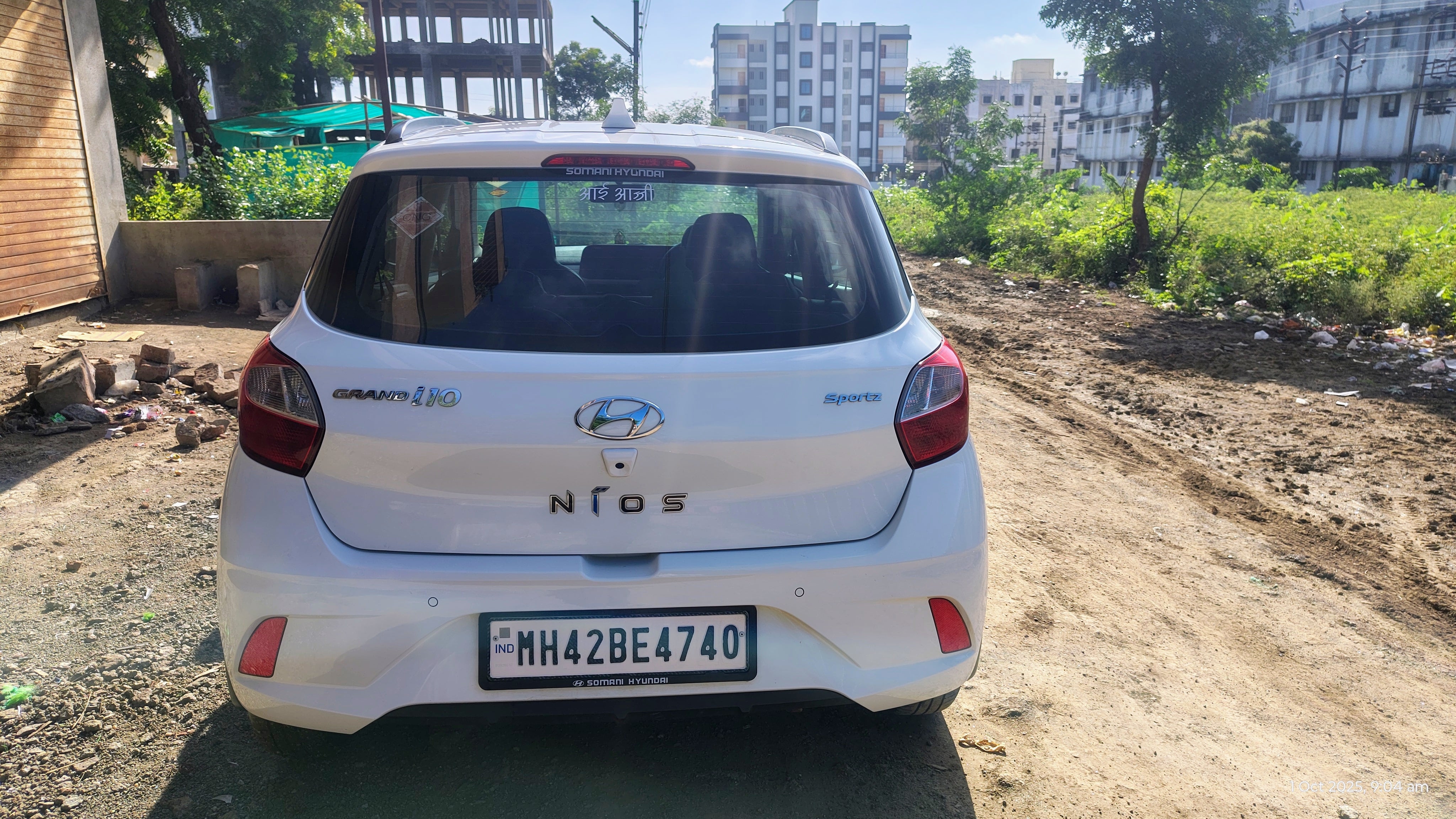 Rear view of a atlas-white Hyundai Grand i10 Nios Sportz