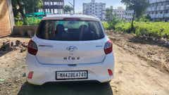 Rear view of a atlas-white Hyundai Grand i10 Nios Sportz