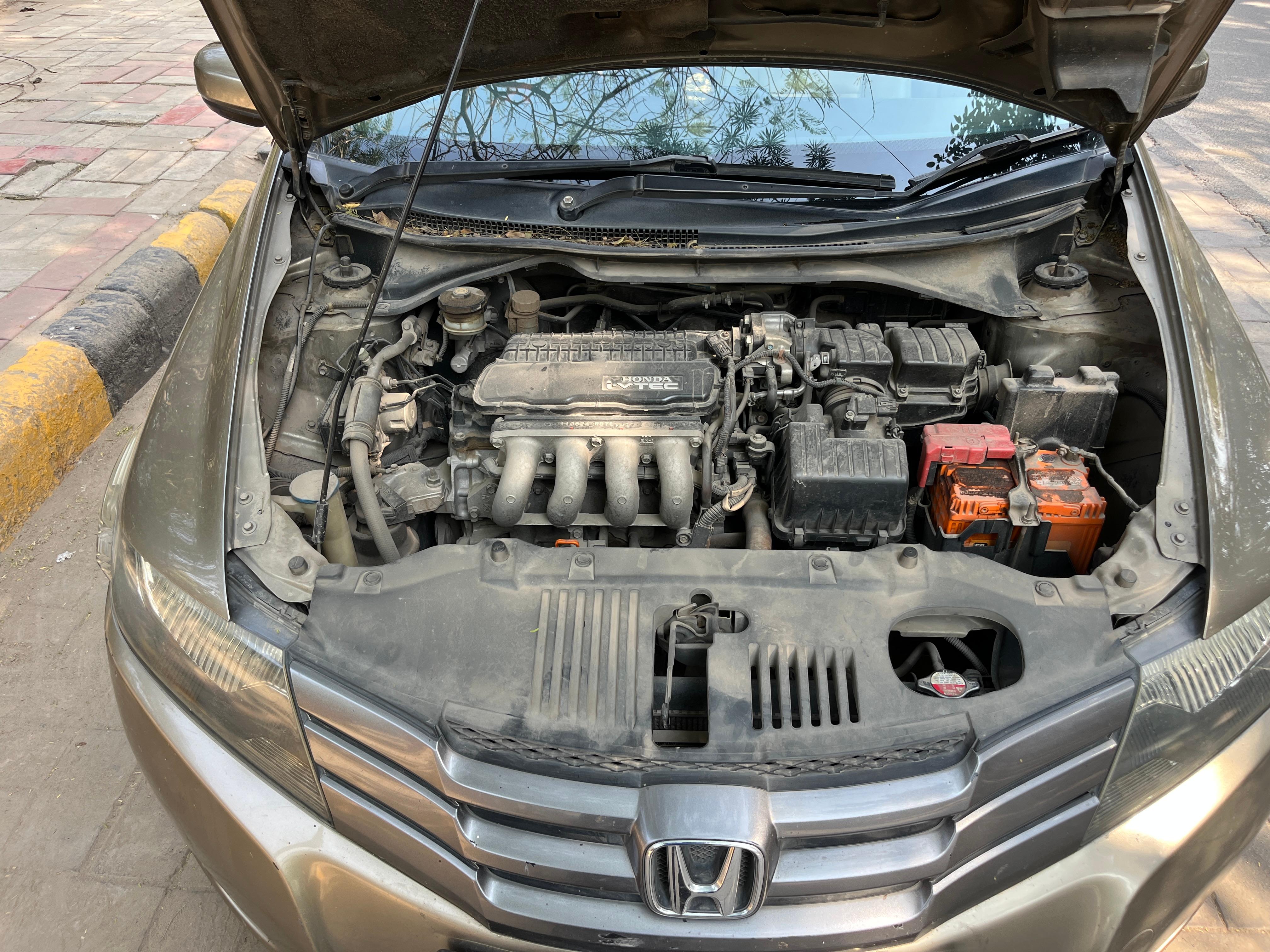 Engine bay of a Honda City with the hood open