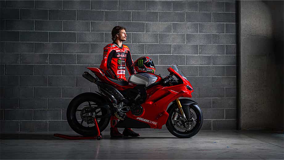 Side view of a Ducati Red Ducati Panigale V4 R motorcycle with rider