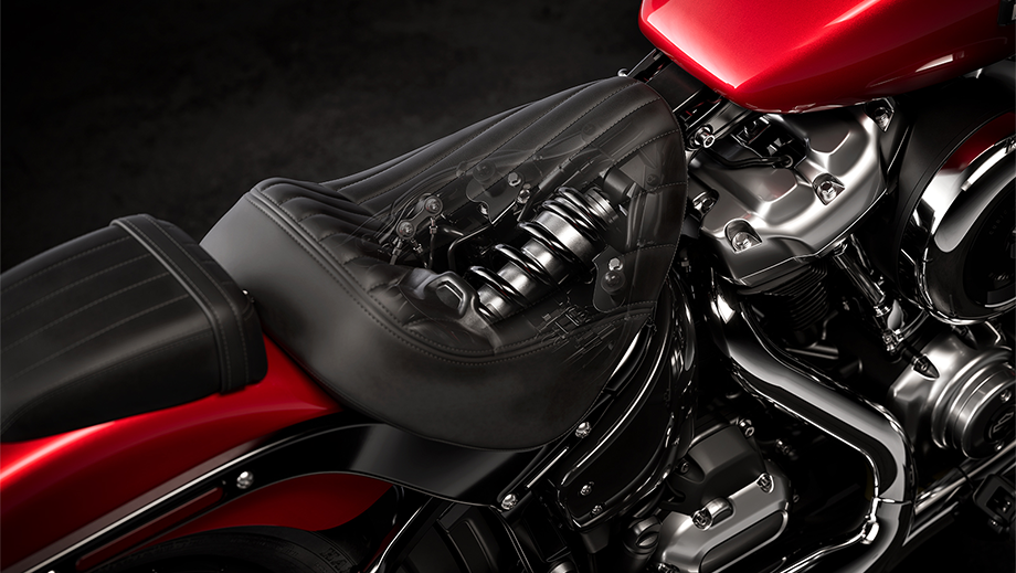 Close-up of seat and suspension area of a brilliant red Harley-Davidson Street Bob