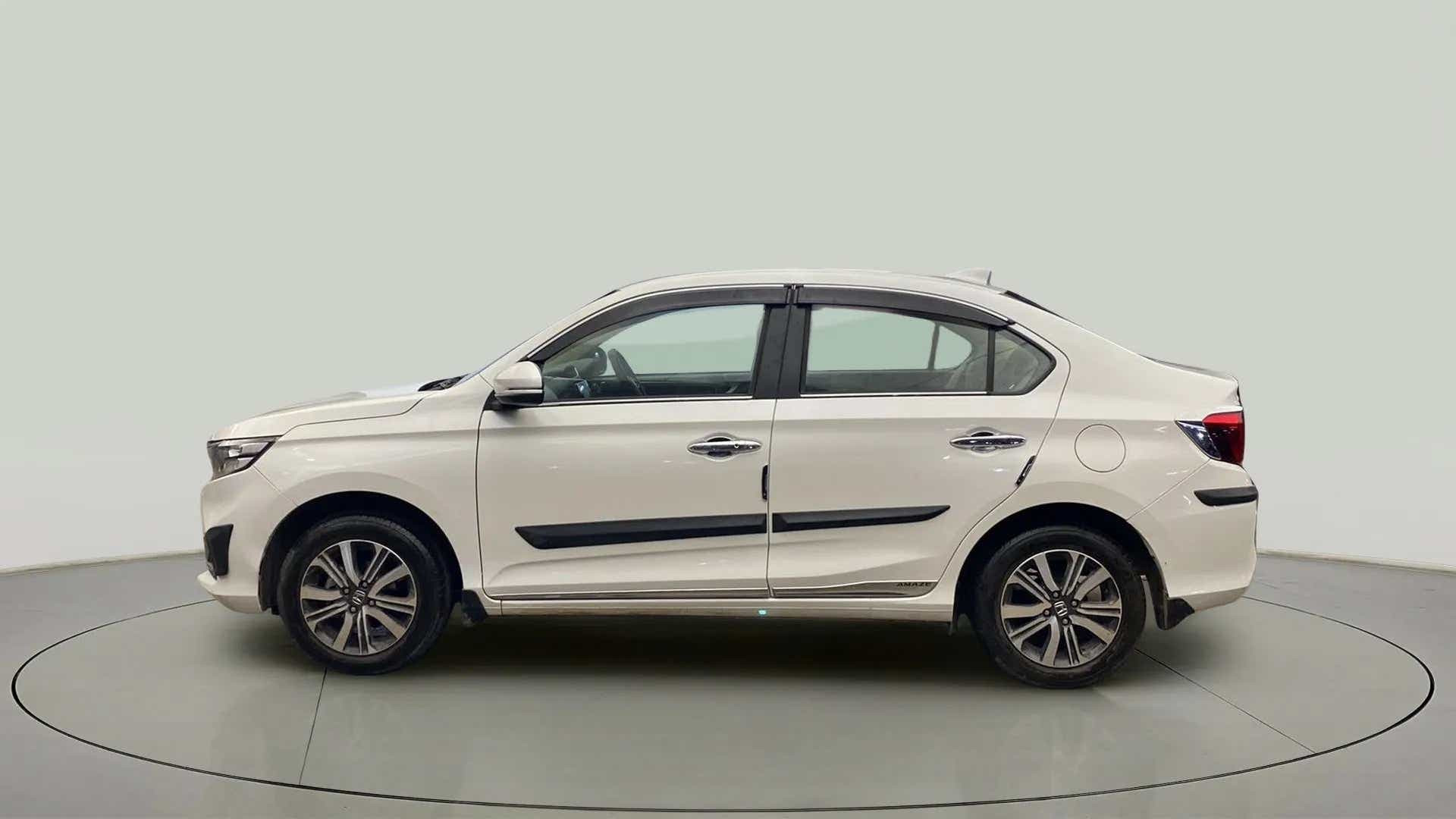 Side view of a platinum white pearl Honda Amaze