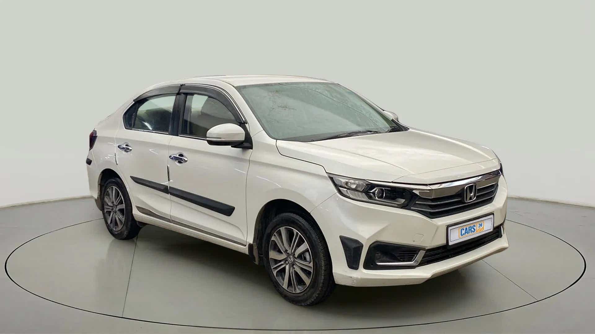 Front three-quarter view of a platinum white pearl Honda Amaze