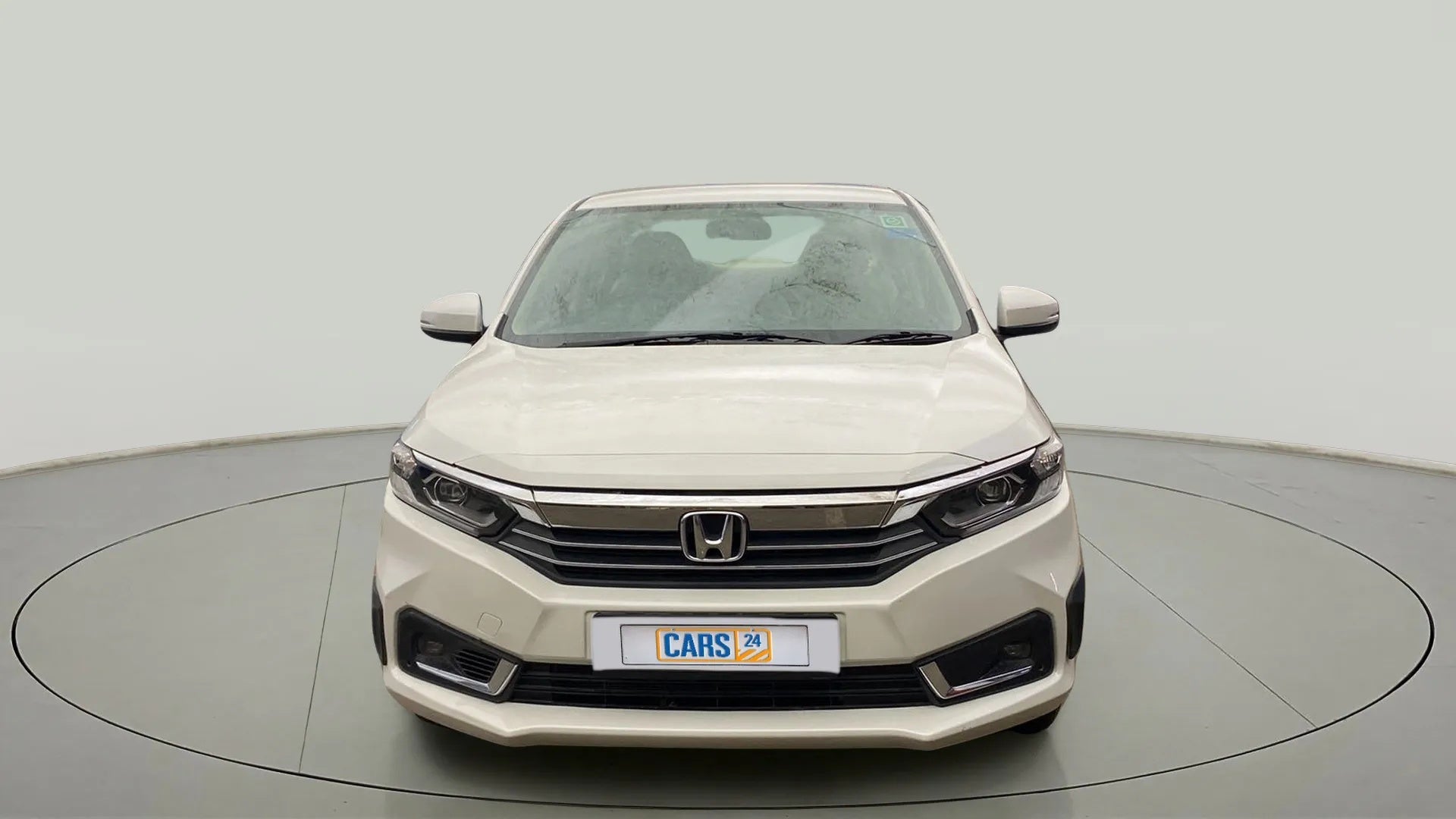 Front view of a Platinum White Pearl Honda Amaze