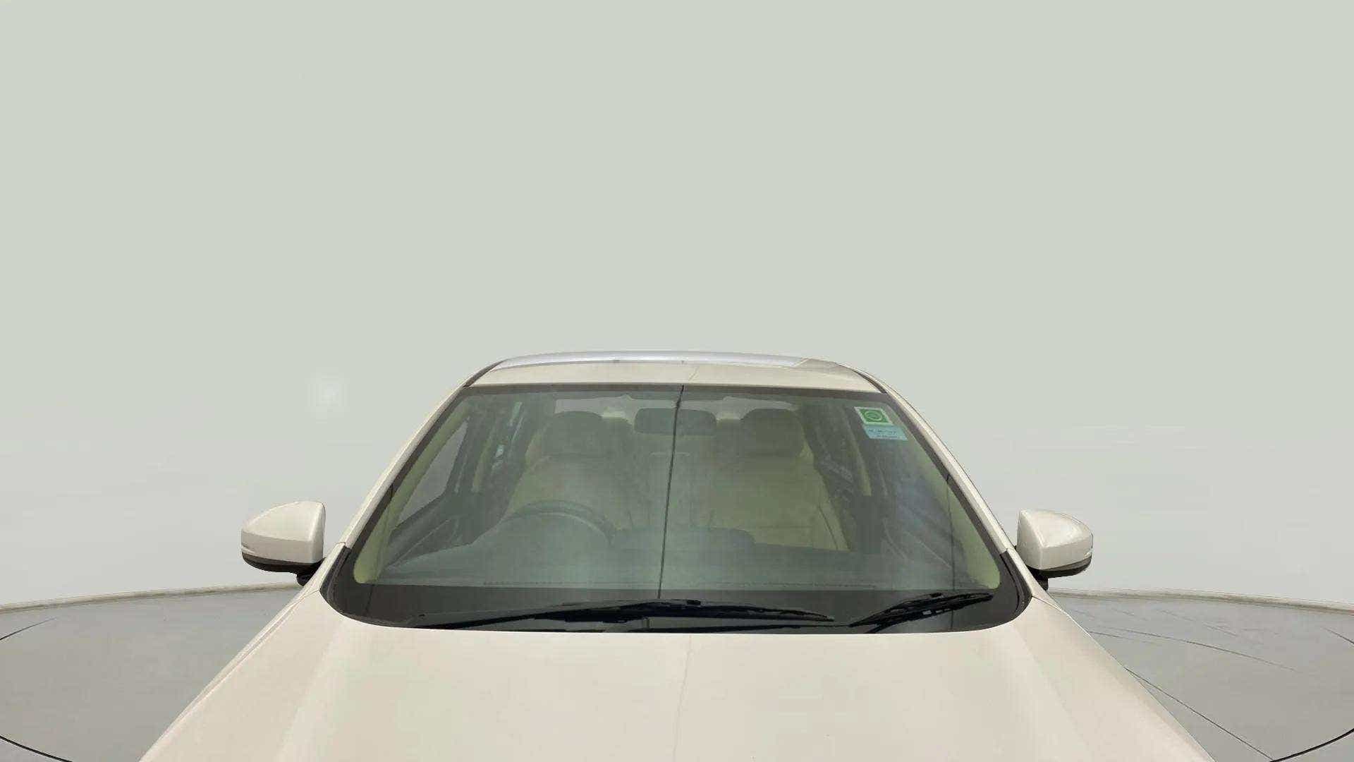 Front windshield view of a Platinum White Pearl Honda Amaze