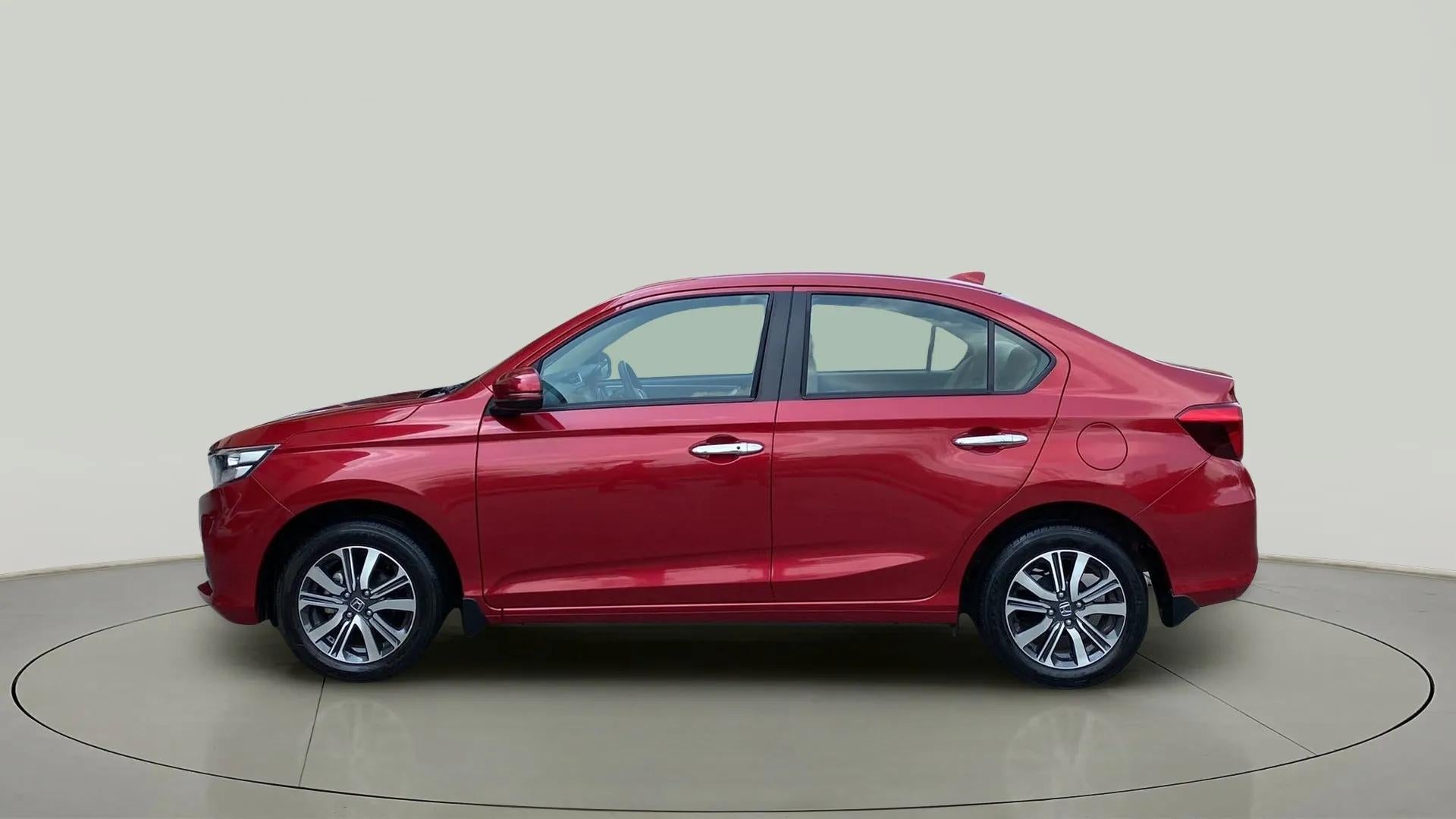 Side view of a Radiant Red Metallic Honda Amaze