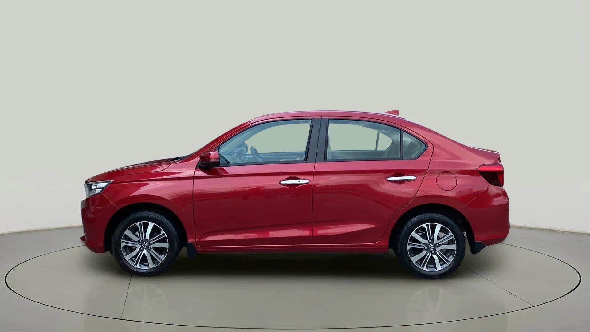 Side view of a Radiant Red Metallic Honda Amaze