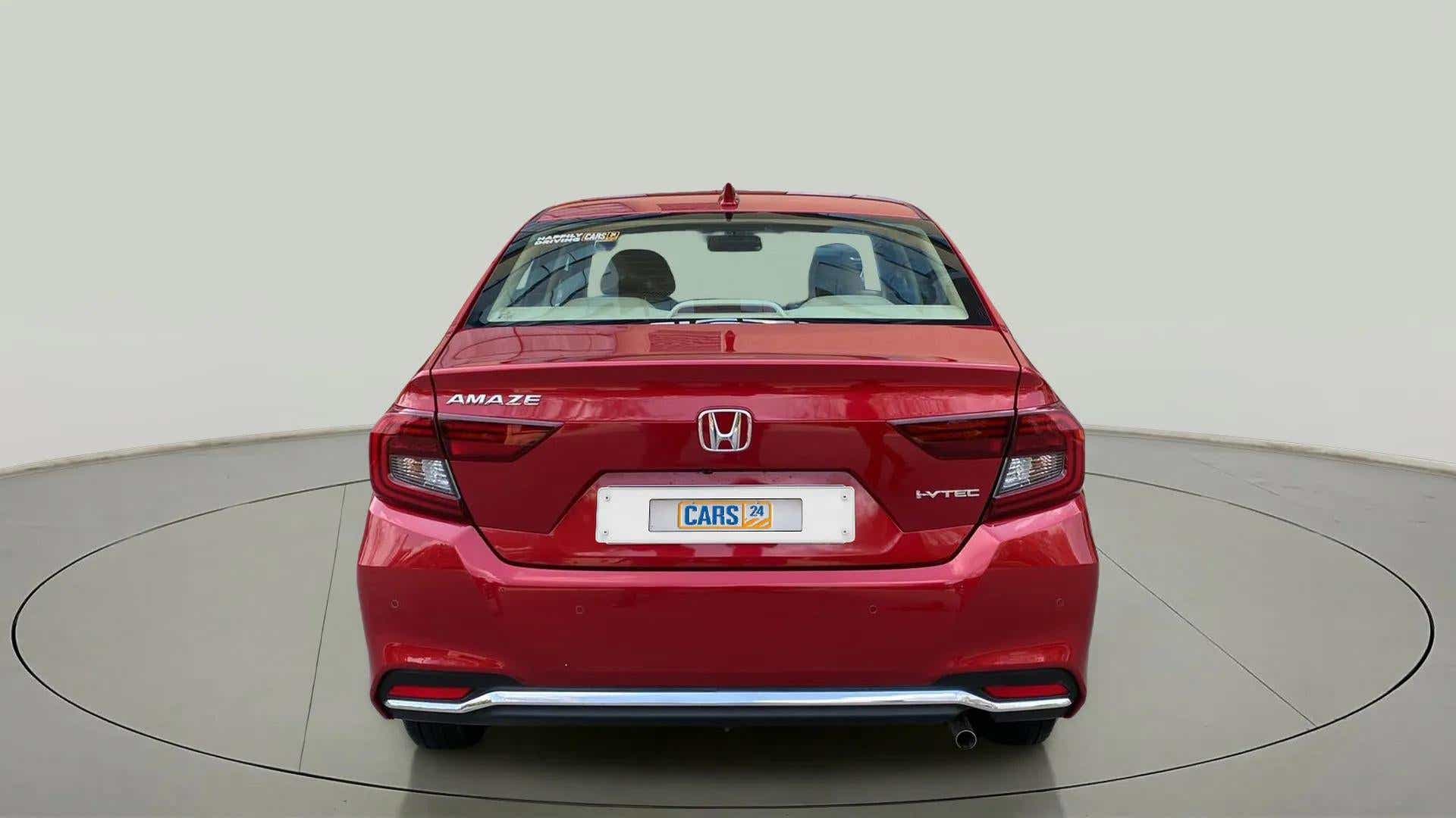 Rear view of a Radiant Red Metallic Honda Amaze