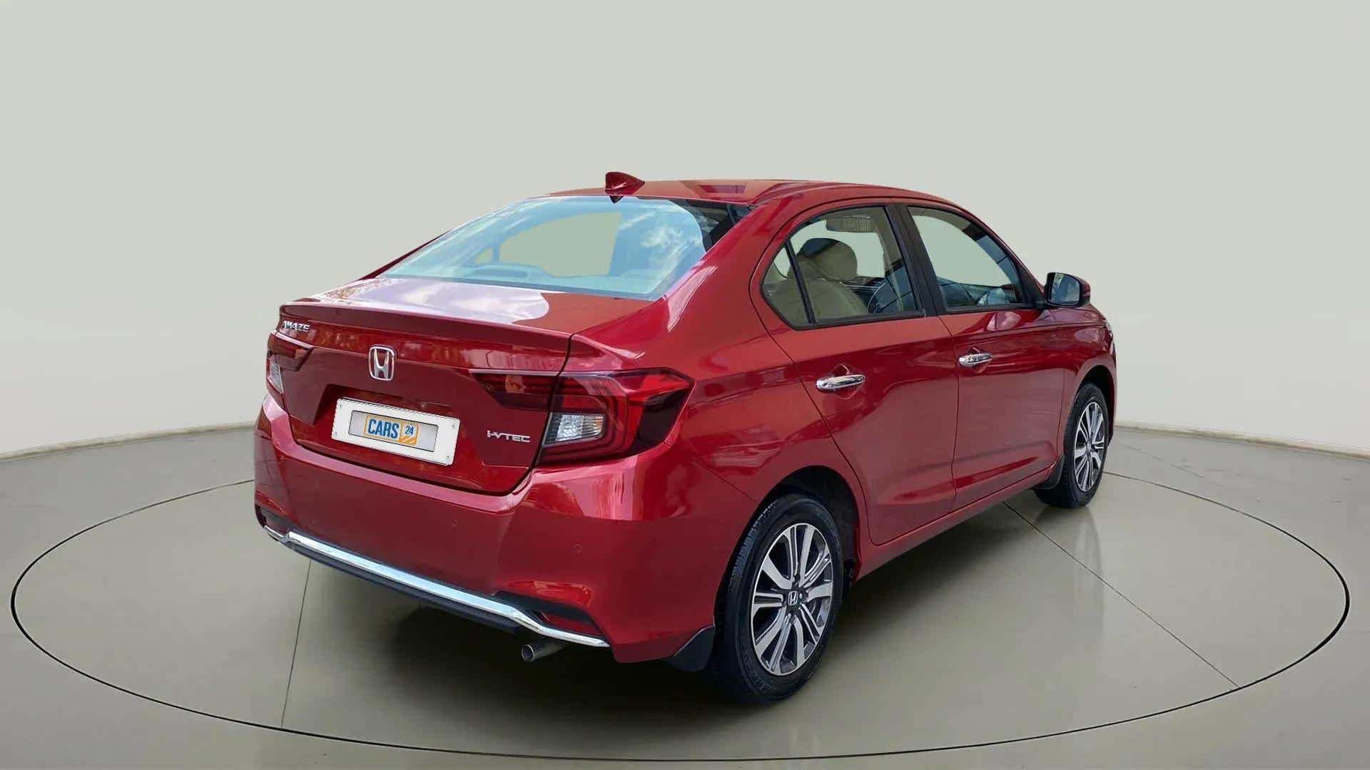 Rear three-quarter view of a radiant red metallic Honda Amaze