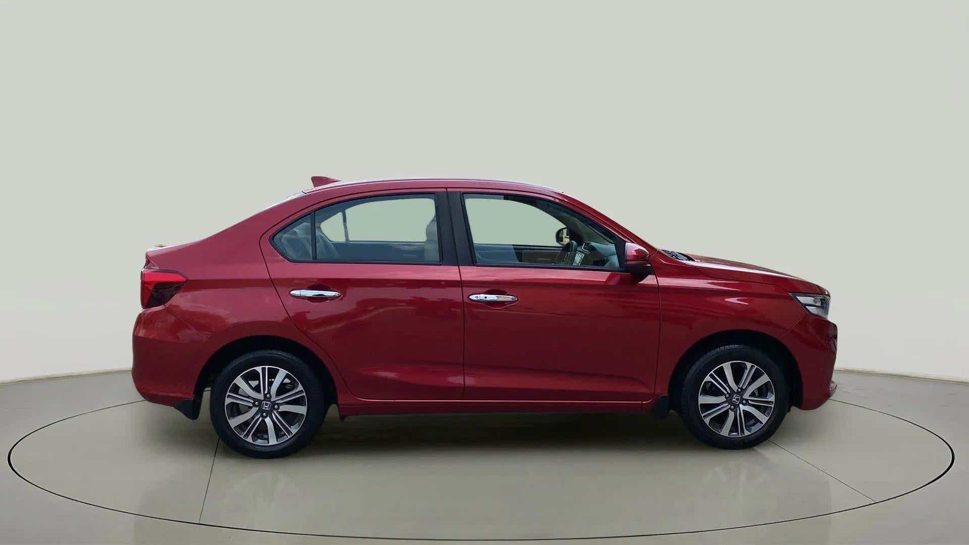 Side view of a radiant red metallic Honda Amaze