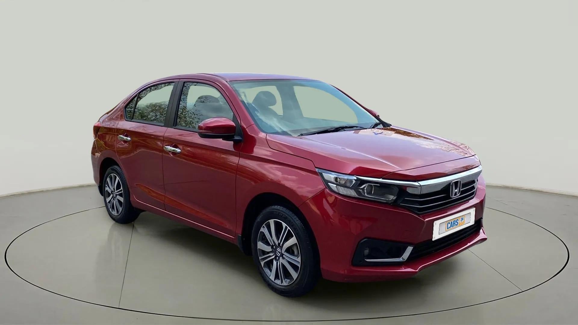 Front three-quarter view of a Radiant Red Metallic Honda Amaze